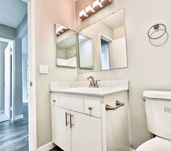 A bathroom with a sink and a mirror